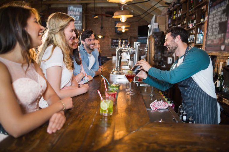 A bartender engaging guests A bartender engaging guests