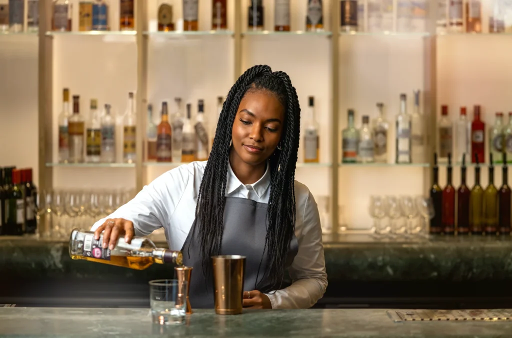 A bartender pouring a drink
